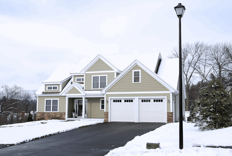 A luxury home in the winter. Is a Heated Driveway Worth It? Read the article at the Betty Most Agency.